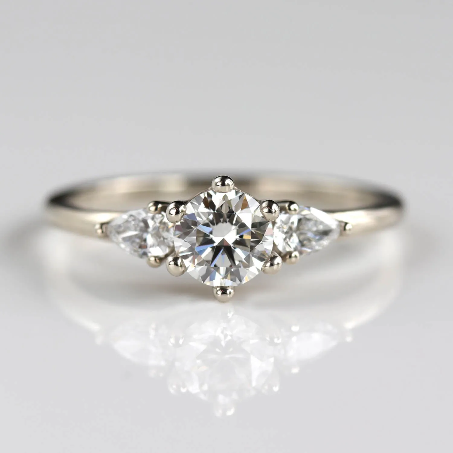 5mm Prong-set Three Stone Ring with Pear-Shaped Side Stones •