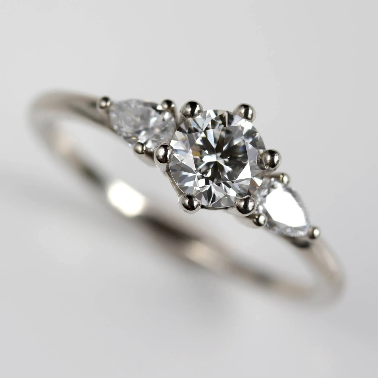 5mm Prong-set Three Stone Ring with Pear-Shaped Side Stones •